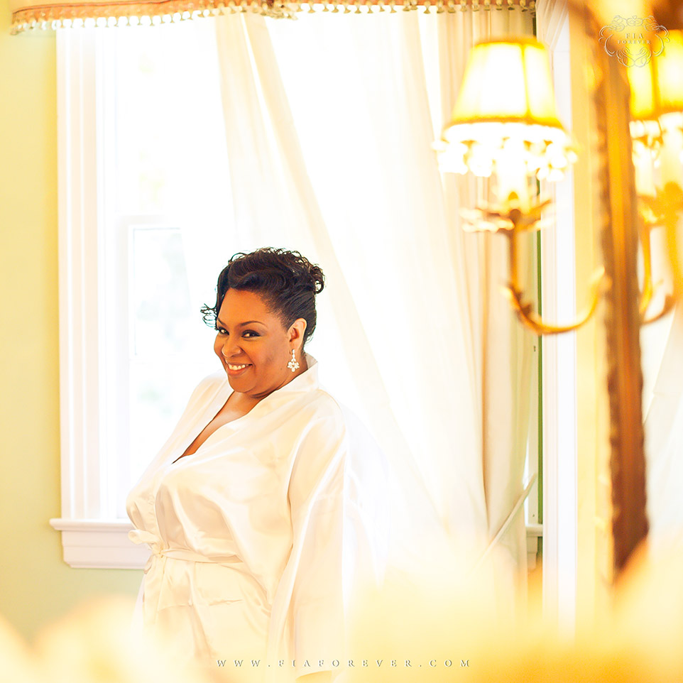 Bride in gown before putting on her dress at Legare Waring House. Photograph by Charleston Wedding Photographer Fia Forever.