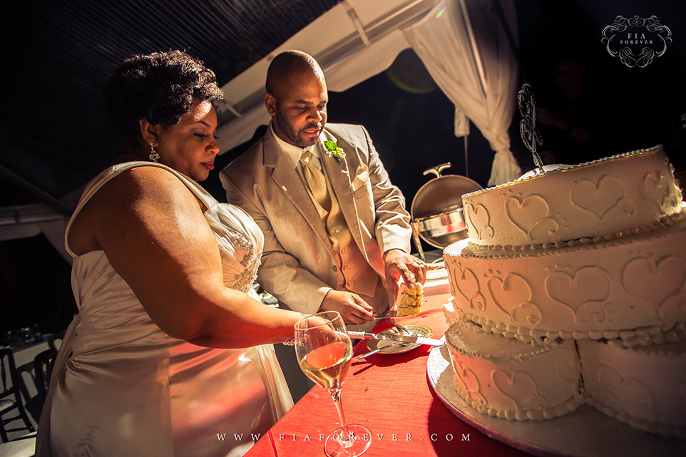 Bride and Groom Cut Wedding Cake at Legare Waring House, Charleston, SC. Photograph by Charleston Wedding Photographer Fia Forever.