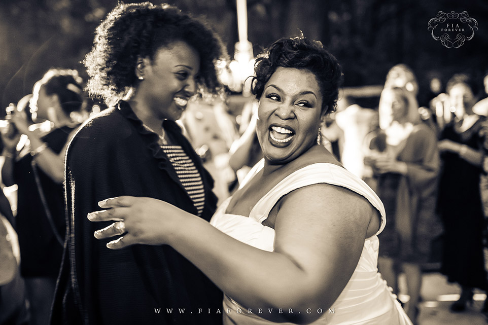 Bride with loved ones on dance floor at Legare Waring House, Charleston, SC. Photo by Wedding Photographer in Charleston, Fia Forever.