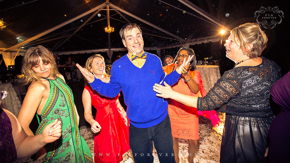 Wedding guests having a great time on dance floor at Legare Waring House, Charleston, SC. Photo by Wedding Photographer in Charleston, Fia Forever.
