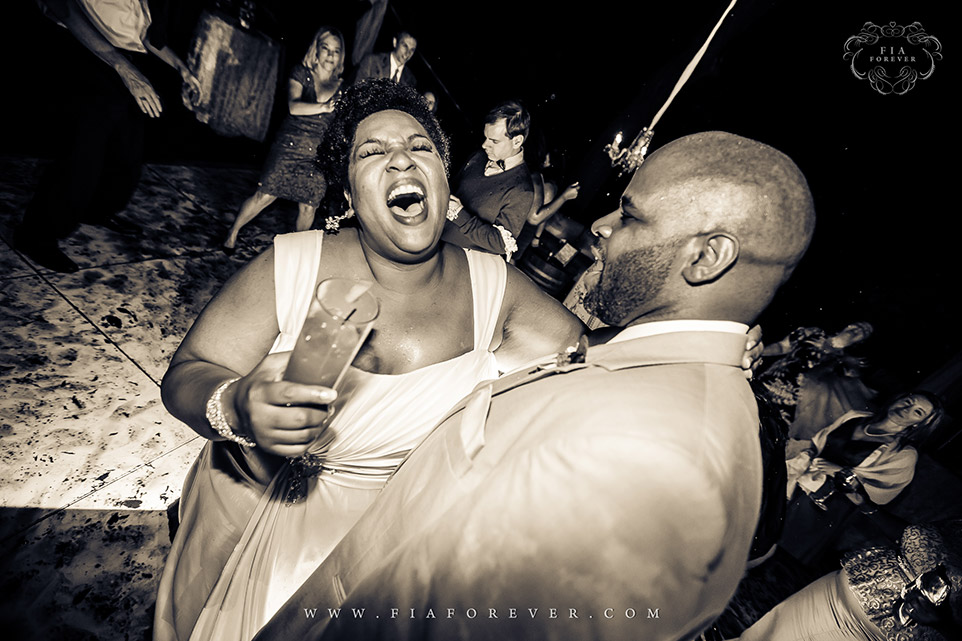 Bride having a great time on dance floor at Legare Waring House, Charleston, SC. Photo by Wedding Photographer in Charleston, Fia Forever.