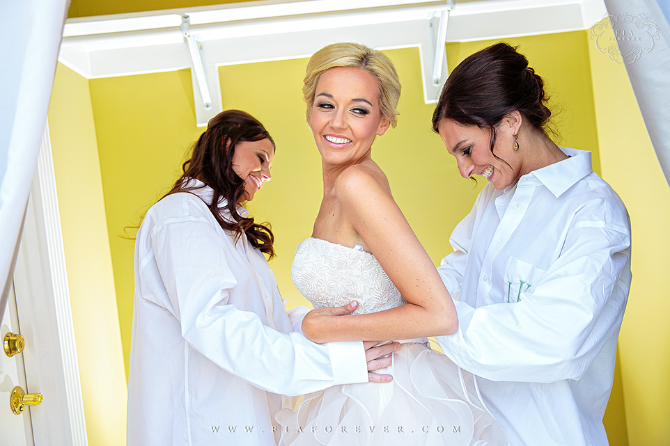 Bridesmaids-helping-bride-with-her-dress-photo-by-wedding-photographers-charleston-sc-Fia-Forever